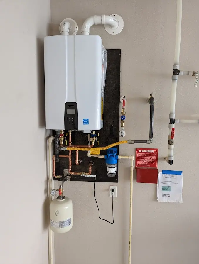 Professional plumber installing copper piping in a Russell home